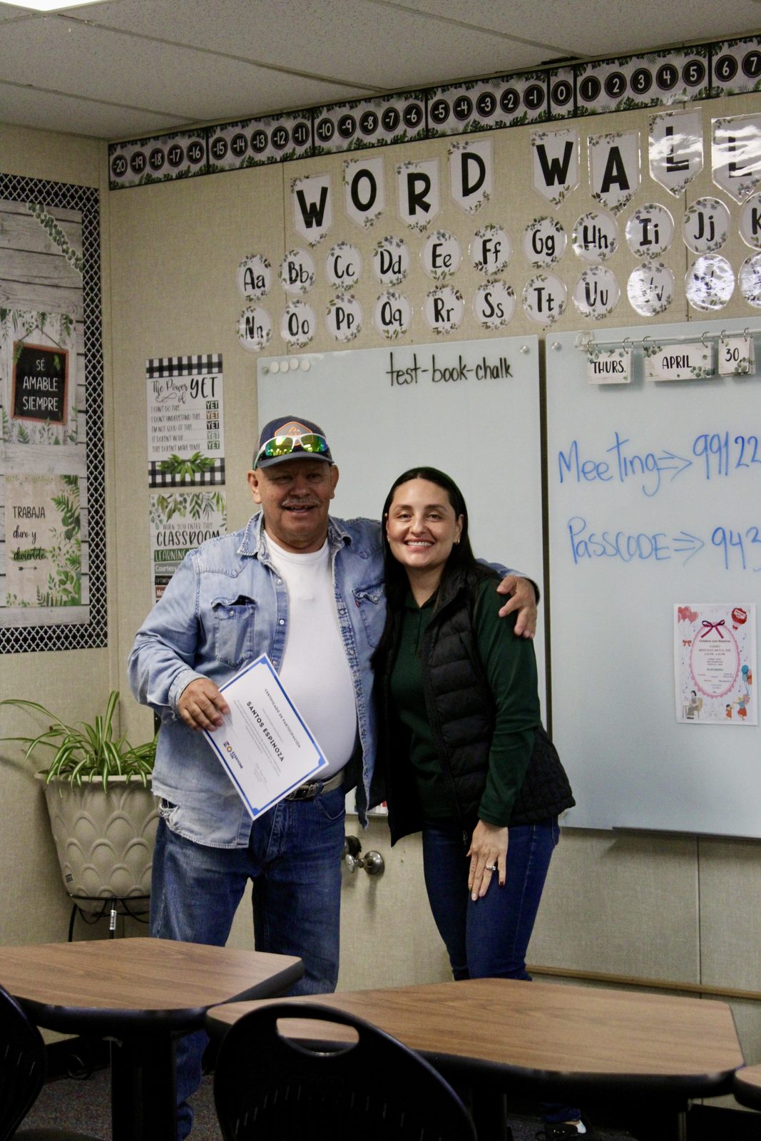 A farmworker receiving a certificate after completing a know-your-rights workshop